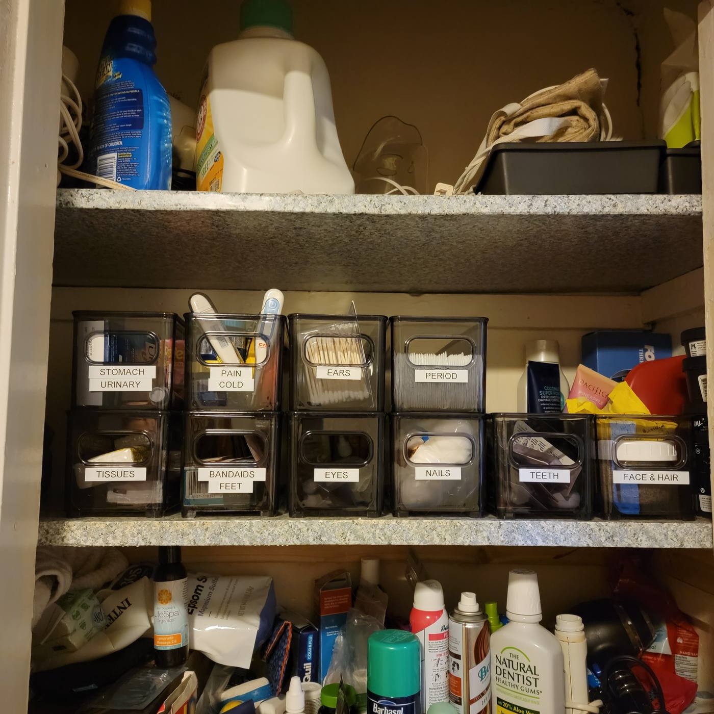 Bathroom shelves crowded with loose bottles and supplies, then the same shelves with items sorted into labeled clear bins