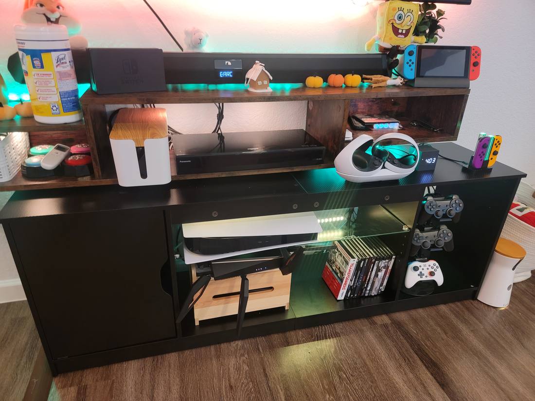 An assembled TV cabinet with media equipment arranged on its shelves